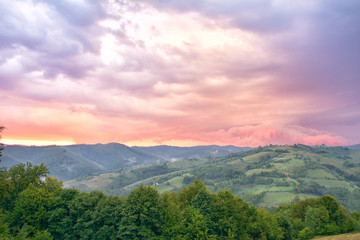 Fototapeta na wymiar Majestic sunset in the mountains landscape. Overcast sky before storm. Carpathian, Romania, Europe. Beauty world.