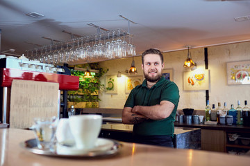 Fototapeta na wymiar Portrait of a bartender barista waiter at the workplace in bar.