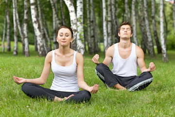 Young couple exercising in park