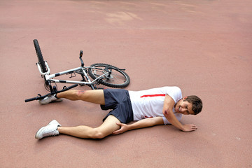 Naklejka premium Young man injured during riding a bike