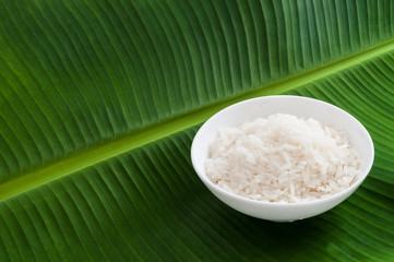 Plain Jasmine white rice in bowl on natural banana leaf