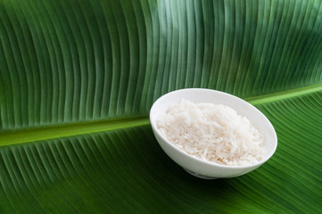 Plain Jasmine white rice in bowl on natural banana leaf