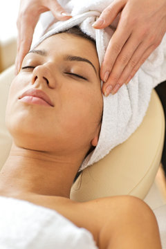 Young woman receiving energy therapy, eyes closed