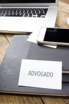 Advogado, Portuguese Text For Attorney Business Card On Office Desktop With Electronic Devices