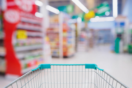 Shopping cart with Abstract blurred supermarket aisle and shelves