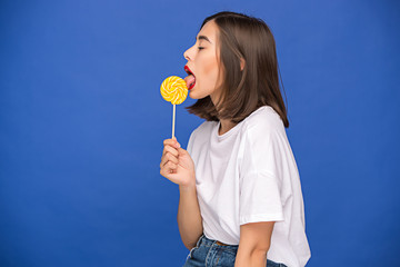 The young woman with colorful lollipop