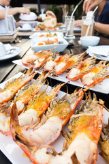 Grilled river prawns or shrimp on white dish in restaurant.selective focus