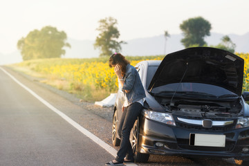 Broken car. Lady standing on the road