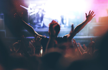 Rear view of a man enjoying a concert