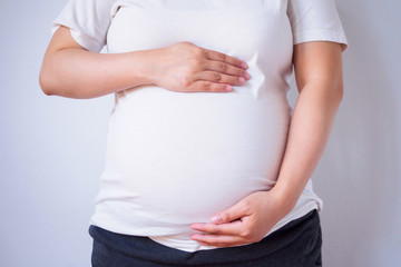 pregnant woman touching her belly