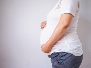 pregnant woman touching her belly