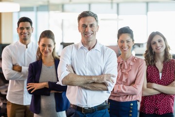 Business executives with arms crossed smiling