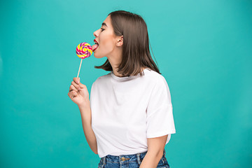 The young woman with colorful lollipop