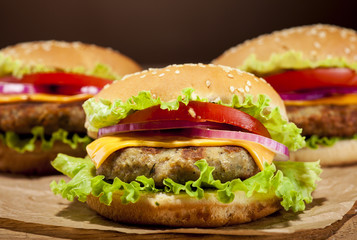 Fresh burgers on wooden background