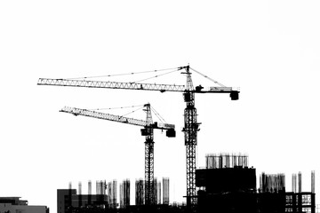 Construction site with cranes on silhouette background