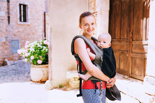 Mother With Baby In Carrier In The Old Town Of Pula, Croatia.