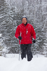 Fototapeta na wymiar senior in winter on snow with skis cross-country skiing