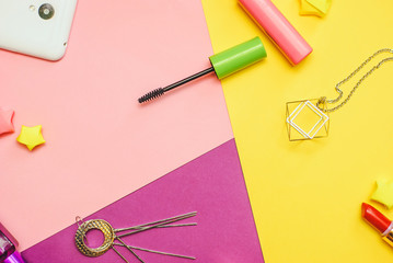 Flat lay photography with Cosmetics and aссessories on colorful background, Overhead view of essential beauty items for woman