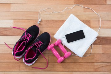 Mobile phone with headphones, shoes, towel and dumbbells