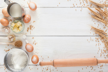 Baking ingredients on white rustic wood background, copy space
