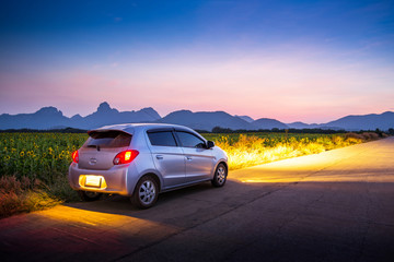 Obraz na płótnie Canvas Travel car with sunset and landscape view.