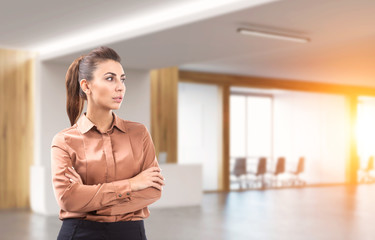 Woman in brown in office lobby