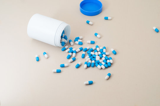 Plastic container with blue medical drugs on floor