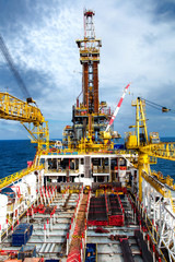Offshore oil and rig platform in sunset or sunrise time. Construction of production process in the...