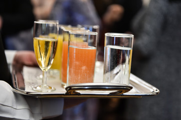 Waiter holding a tray with beverages during cocktail party