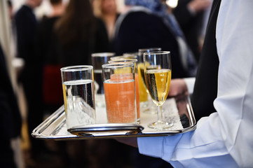 Waiter holding a tray with beverages during cocktail party