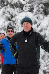 seniors in winter on snow with skis cross-country skiing