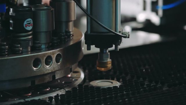 metal processing at workshop. Modern tool in heavy industry. Dangerous job. High precision manufacture of steel parts. Automatic work for ironwork.Automation of process indoors. Close up computer cnc