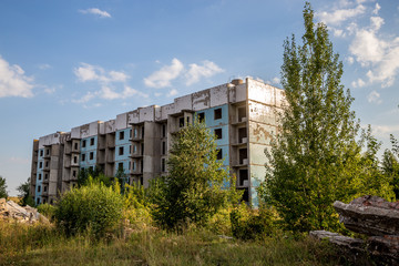 Fototapeta na wymiar Abandoned five-story house, summer, Russia, Samara region