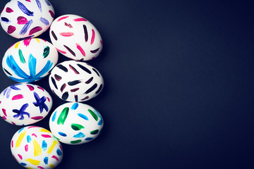 Easter eggs on a black background. Easter ideas. Easter egg. Space for text. Image in trendy toning.