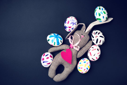Easter bunny on a black background. Rabbit. Easter ideas. Easter eggs. Space for text. Image in trendy toning.