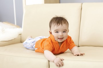 Cute baby boy on sofa