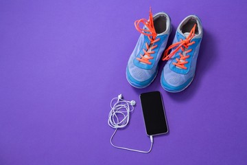 Sneakers, mobile phone with headphones