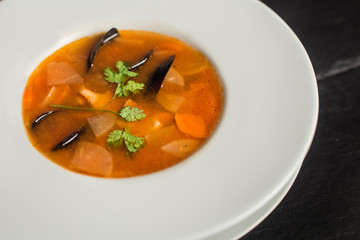 Tasty mussel soup with carrots. Traditional food. Restaurant