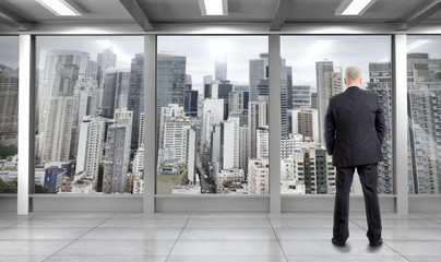 Businessman looking  through window