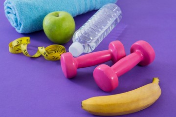 Dumbbell, apple, towel, water bottle and measuring tape