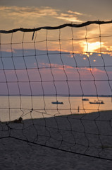 Sunset at the beach thru volleyball nest, Sithonia, Greece