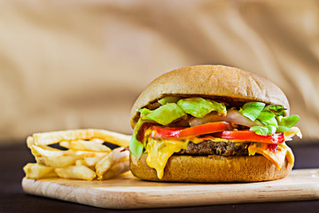 Close up cheese burger on wooden board