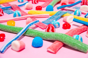 Mix of different types of colorful candies jellies