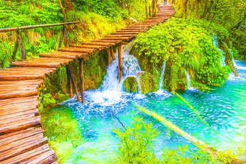 Deep forest, cascades and tourist path in Plitvice lakes national park, Croatia.