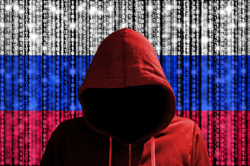 Russian hacker in front of digital datastream flag