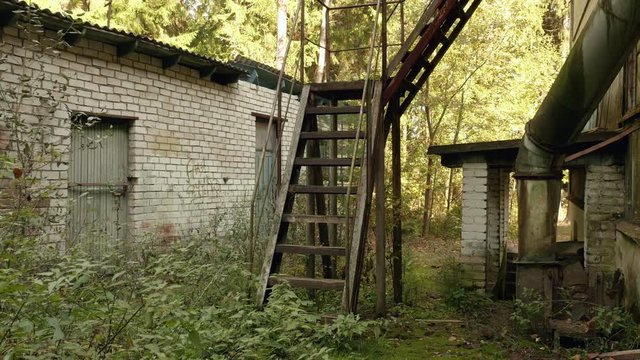 Stairs of the abandoned factory. Autumn daytime. Smooth dolly shot