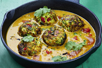 Courgette fritters in vegetable sauce 