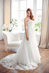 Bride in gorgeous wedding dress indoors. Wedding fashion