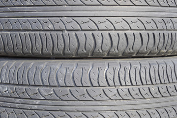 The background of the tread pattern of the car wheel. Rubber tir