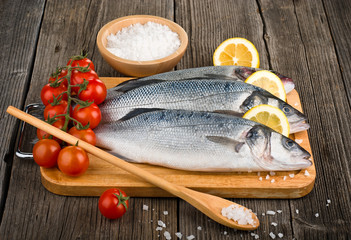 Raw sea bass on a wooden board